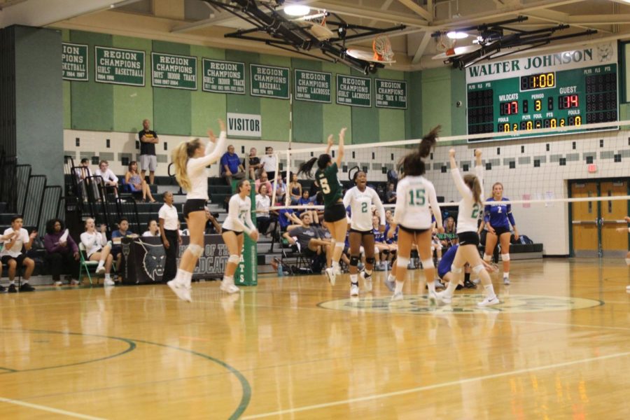 WJ girls volleyball celebrate after scoring a point against Sherwood High School.