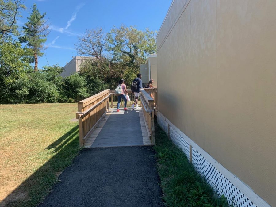 Students are seen walking to their sixth period portable class. The walk to class can be warm with sunny weather outside, but this isnt always the case, making the portables inconvenient for some students.