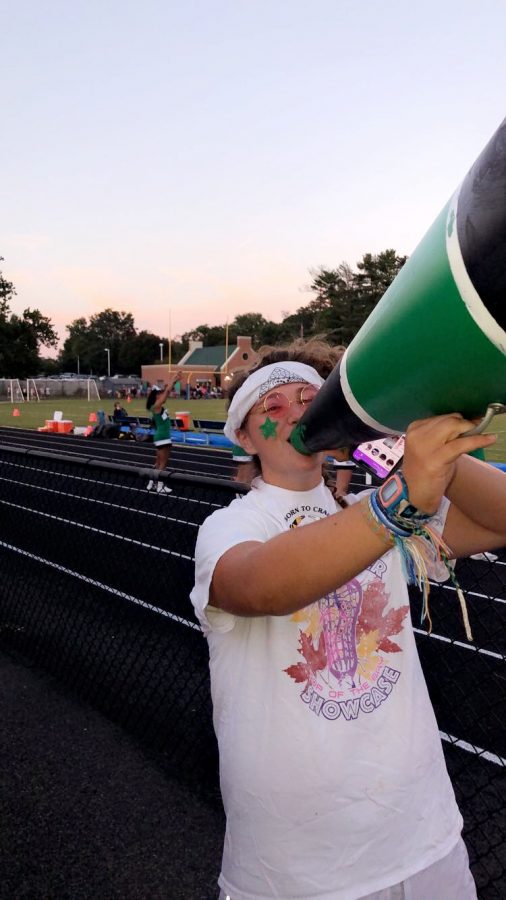 Senior class president Colleen Besche encourages freshman to participate in school spirit at football games.