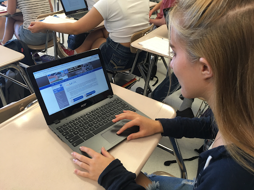 Junior Saoirse Tolbert checks up on her grades on the MCPS Portal website. Since the 50 percent rule will remain in place, all grades that students receive as a zero, will be shown as a 50 percent on MCPS Portal.