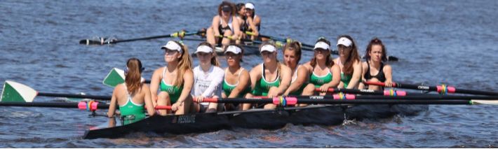 Nine girls on the varsity girls team race down the river at a regatta. Succeeding in regattas during competition seasons is critical for sending a boat to Nationals.