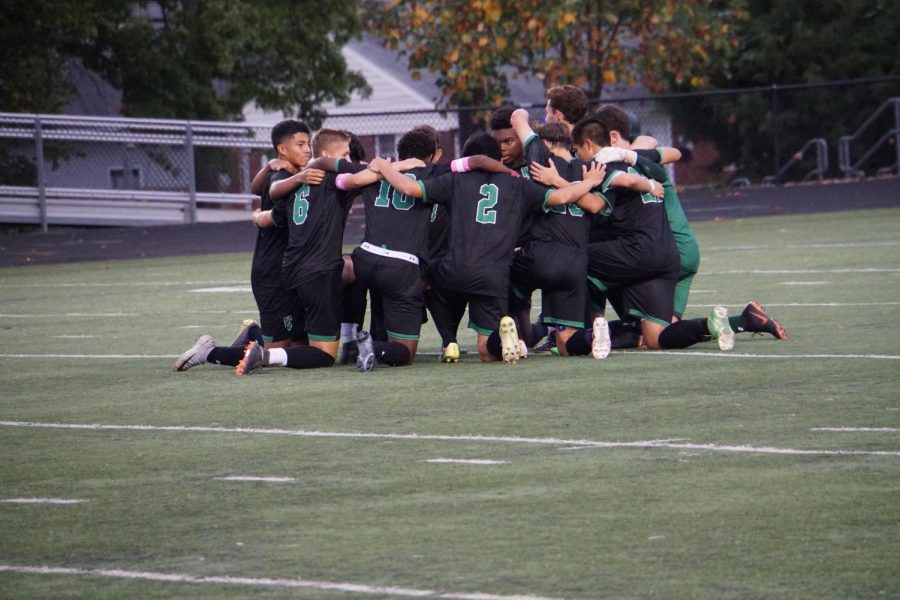 Boys varsity soccer huddles up pregame. They look to get to the old heights set by the 2016 state championship team.