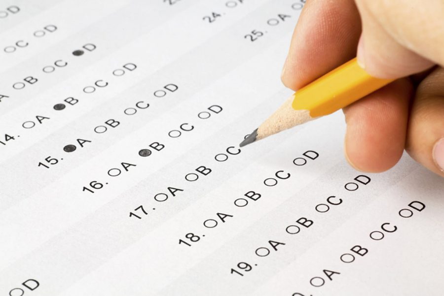 Student fills in scantron during A.P. exam. 