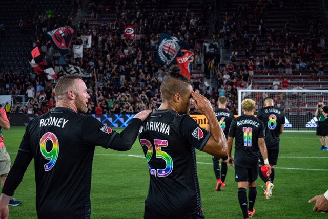 D.C. United forward Quincy Amarikwa strolls towards the stands with teammate Wayne Rooney after a game. The pair have helped D.C. United reach playoff birth this season.