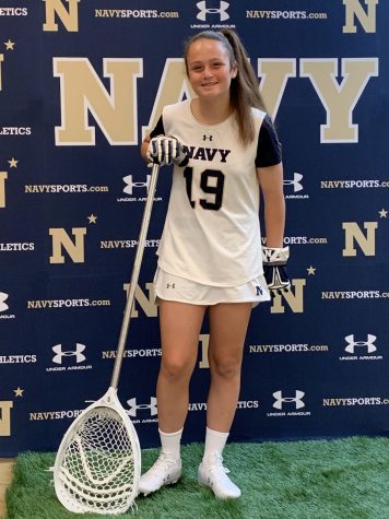 Junior  lacrosse player Emma Richardell poses in her new Navy gear. After she finishes her education, she will be in the US Navy for five years.