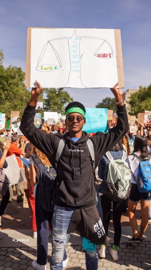 Senior Yerim Kone holds up a sign expressing his frustration with the government and how they are handling climate change during the massive protest.