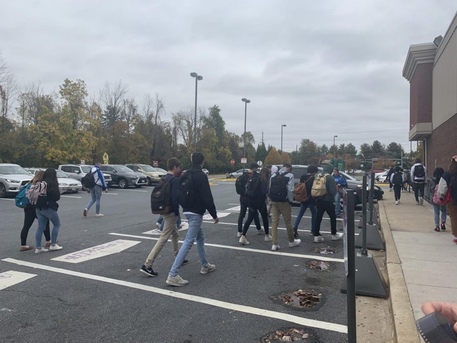 Students walk through the Giant parking lot during lunch time. Teachers warned students to be cautious when crossing.