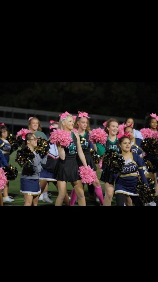 Joy and WJ cheer performs during halftime at the football game.The crowd cheers extra loud for the exciting entertainment.