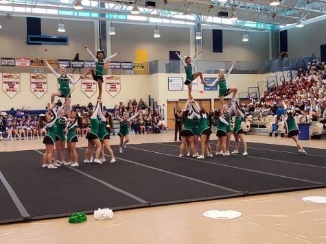 The cheer team proves they are a pro at stunts.