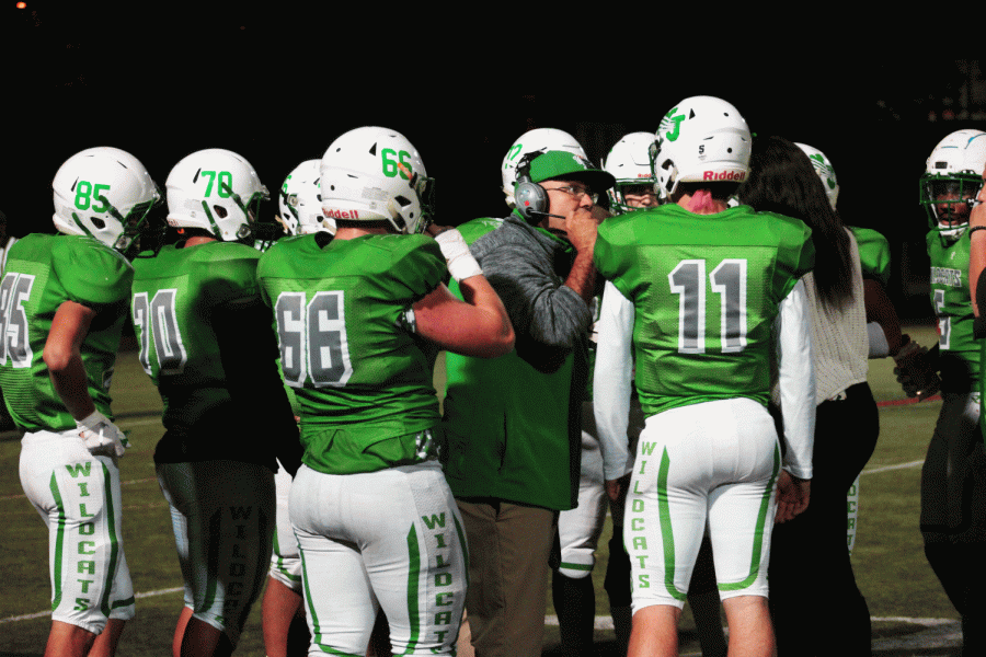 Varsity football coach Larry Hurd Jr. talks to his team at the WJ Homecoming football game. The Wildcats boasted a record season, starting the year at 4-0.