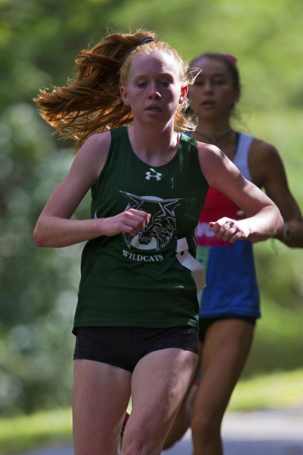 Junior Ella Gaul storms past an opponent during a cross country meet. Gaul, apart of indoor track, looks to contribute to the talented 2019-20 team. 