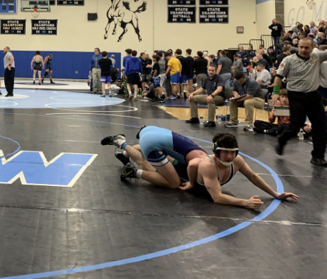 Junior Joseph Meyer gets pinned to the floor by an opposing school’s wrestler. WJ faced off against schools outside of MCPS at a tournament in Bel Air, MD.