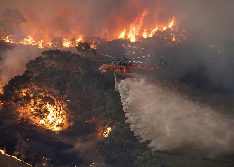 In+this+Monday%2C+Dec.+30%2C+2019+photo+provided+by+State+Government+of+Victoria%2C+a+helicopter+tackles+a+wildfire+in+East+Gippsland%2C+Victoria+state%2C+Australia.+Wildfires+burning+across+Australias+two+most-populous+states+trapped+residents+of+a+seaside+town+in+apocalyptic+conditions+Tuesday%2C+Dec.+31%2C+and+were+feared+to+have+destroyed+many+properties+and+caused+fatalities.+%28State+Government+of+Victoria+via+AP%29