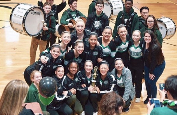 The Poms pose with the drum-line after their third place win at the Damascus Invitational competition.