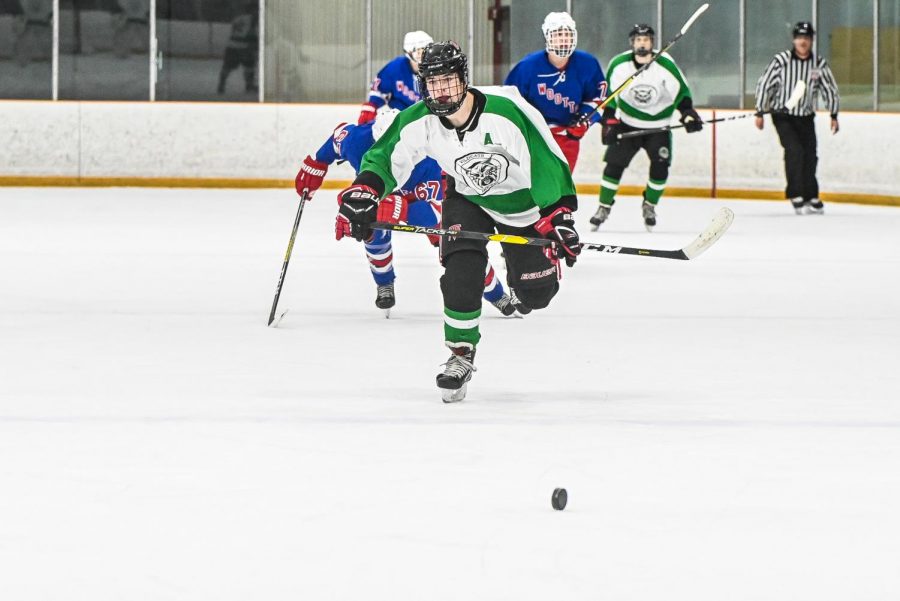 Senior Chris Dorrer chases down a loose puck. The team lost 4-3 but rebounded in their rematch against Wooton with a 3-3 draw