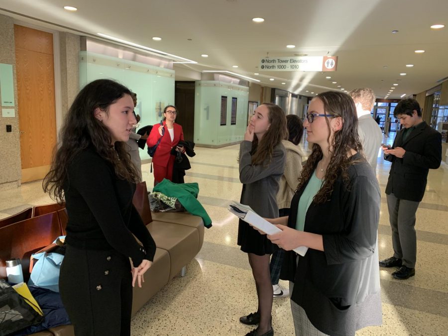 Junior Mia Chai is prepping with her lawyers, juniors Emmie Maisel and Danielle Nevett during a break in their trial. Simmons team concluded their season by making it to the second round of the playoffs.