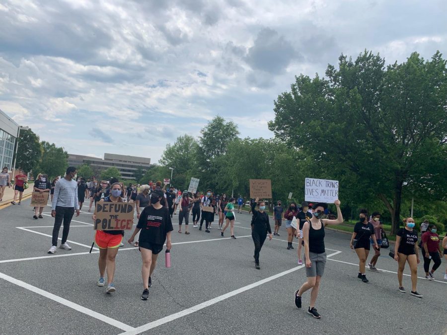 The+crowd+marches+from+WJ+towards+Old+Georgetown+Road%2C+carrying+signs+expressing+anti-racism+sentiment+such+as+Defund+the+Police+and+Black+Trans+Lives+Matter.+This+event+was+organized+by+two+recent+WJ+graduates+and+united+the+local+Bethesda+community+against+racial+injustices.