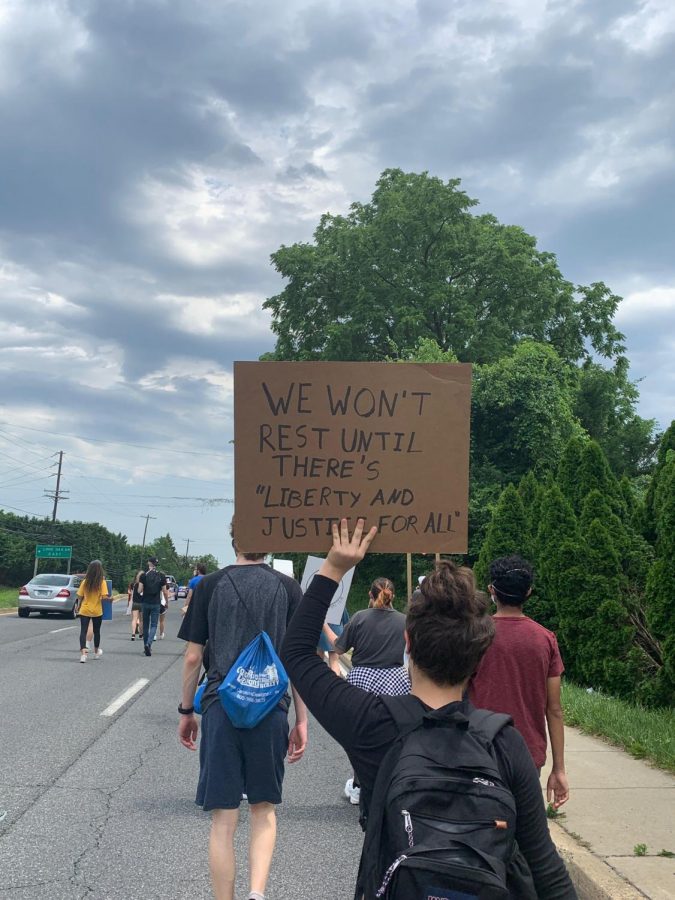 Students march down Old Georgetown Road protesting for police and criminal justice reform.