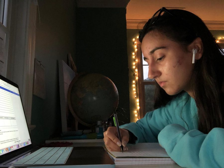 Junior Sophia Maxwell works on her Calculus homework while listening to music.  