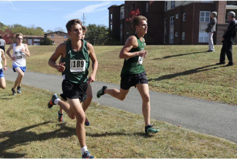 Junior Andrew Schell and Senior Alex Scott running at last years Cross Country County Meet.