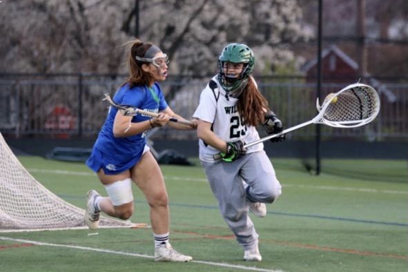 Senior lacrosse player Emma Richardell tries to escape a Churchill defender. Richardells favorite thing about playing lacrosse is getting to play with awesome teammates.