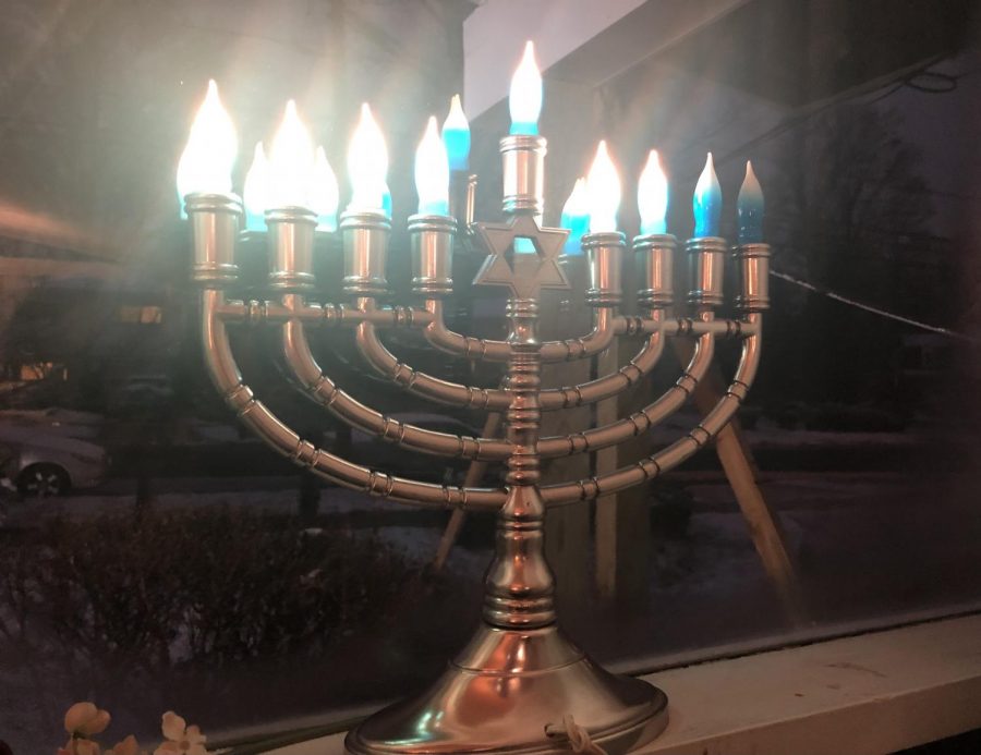 An electric Hanukkiah stands on a windowsill on the sixth night of Hanukkah. The Jewish holiday last for eight days and eight nights.