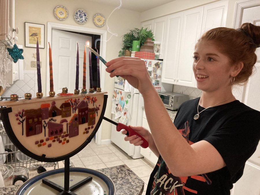 Senior Olivia Zaid lights the Menorah with her family for the 6th night of Hanukkah. Even during a pandemic, families still celebrated and performed holiday traditions.