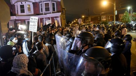 Philadelphia police, donning riot gear, attempt to contain protesters five night before the election.