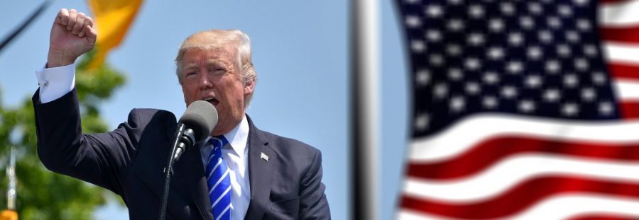 Former U.S. President Donald Trump raises his hand in the air as he gives a speech. Trump did not win the 2020 election, ceding the presidency to Joe Biden.