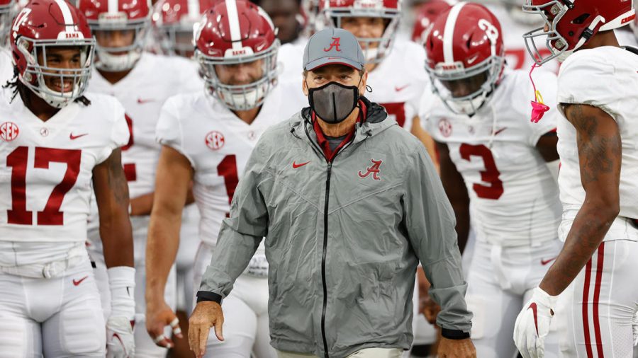 Alabama head coach Nick Saban leads his team onto the field during a pandemic.