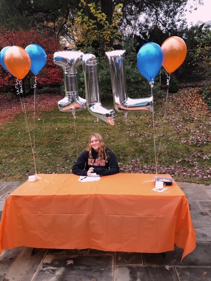 Lights, camera, action! Senior Jane Umhofer smiles as her picture is taken. She committed to the University of Illinois to continue her swimming passion. I am super excited to join a great group of ladies, Umhofer said.
