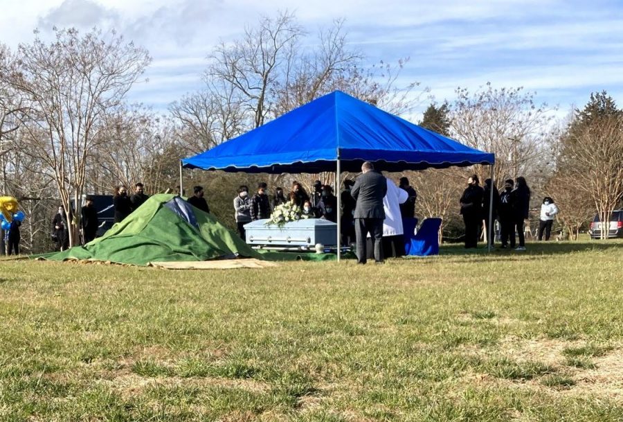 The coffin of Edwin Roberto Juarez Rivera is prepared for burial. He was killed in a gun accident on Christmas day.