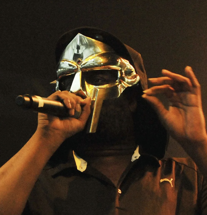 Daniel Dumile (MF DOOM) performing on-stage in his coveted and unmistakable metal mask.