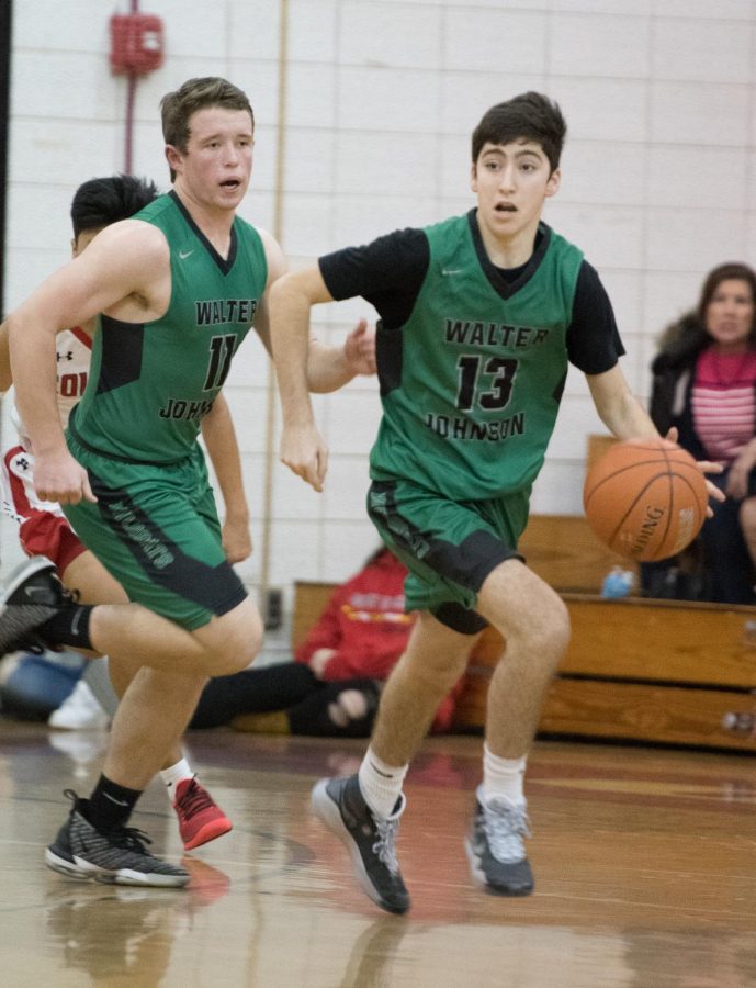 Charlie Newman takes the ball down the court in a basketball game against Wooton High School.