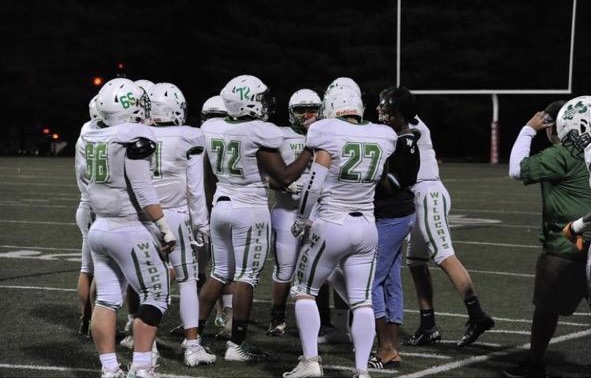 Senior football player Daniel Ticktin huddles to talk with his teammates.   Ticktin has been playing football for WJ since his freshman year of high school. ¨My favorite part of playing football at WJ is the sense of family that we all have, Ticktin said.