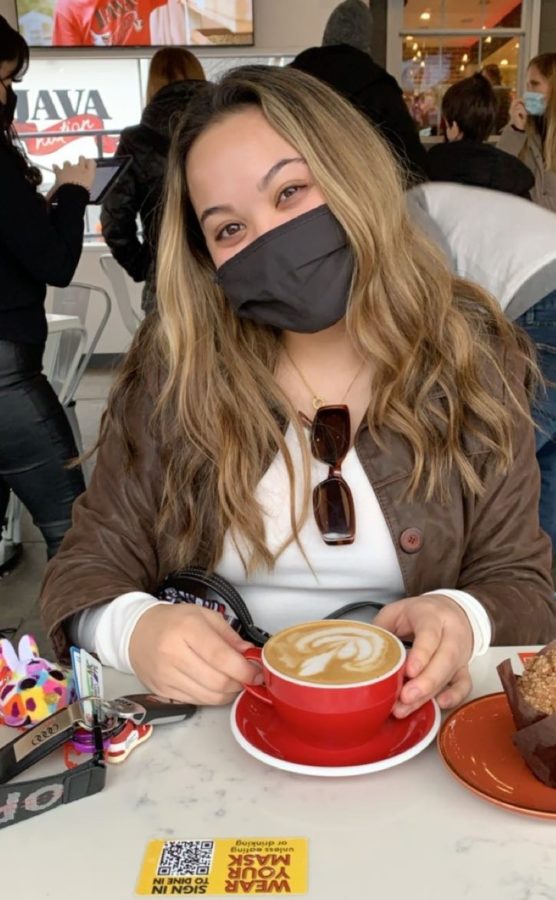 Junior Ella Barrett (not pictured) and junior Julia Beato (pictured) visit Java Nation to review its coffee. Seating is available outside in a COVID-safe tent.