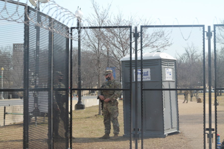 Members of the National Guard converse outside the Capitol.