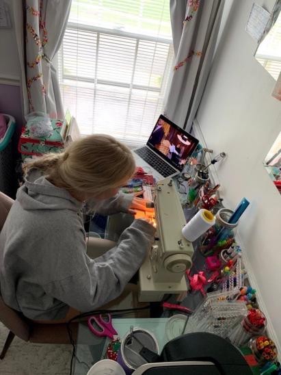 Senior Abby Matson sews facemasks to distribute during the coronavirus pandemic. Matson has sewn about 400 facemasks in total.