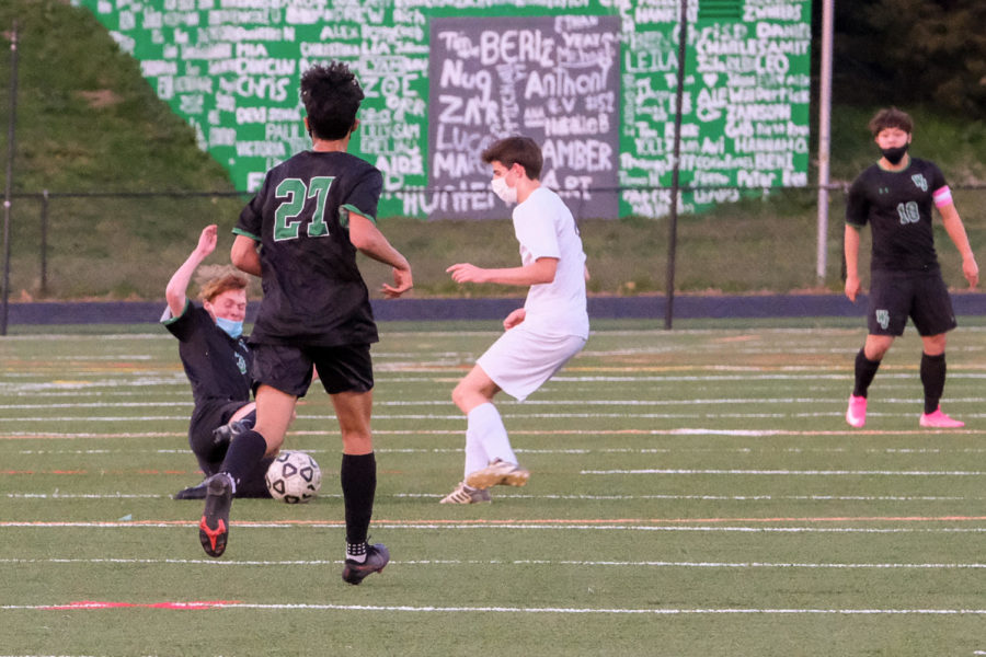 Sophomore Nick Avillo slides in for a tackle and regains possession for the Wildcats.