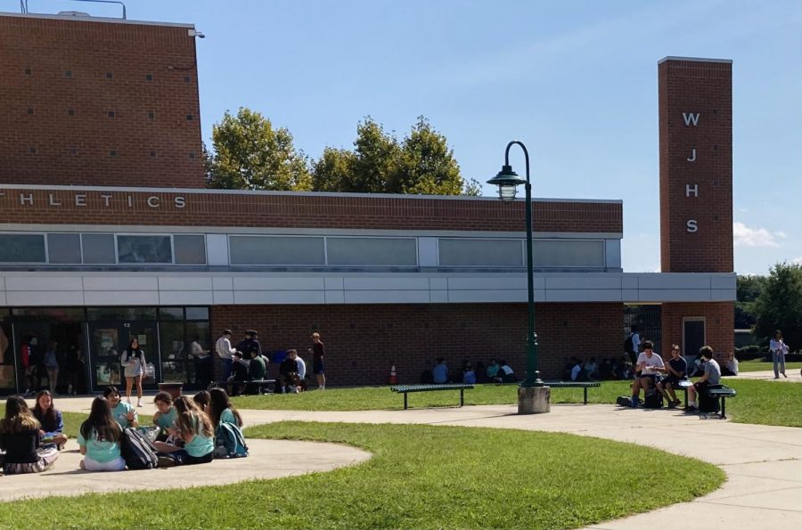 Students enjoy lunch outside of the school building while the weather is seasonal. 