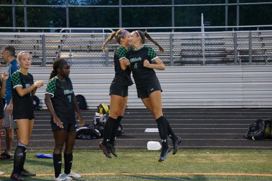 As part of their pregame handshake, juniors Emily Roberts and Isabella Mondelli shoulder bump to hype themselves up before the game. They have done this before every game this season.