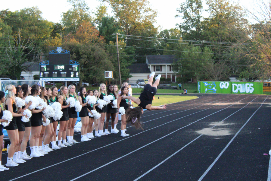 Sophomore Kimberly Shian does a flip during one cheers routines. The squad cheered on the WJ team throughout the whole game, always keeping spirits up.