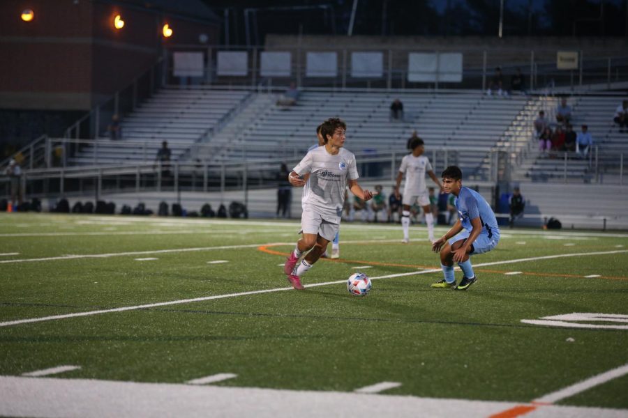 Senior Connor Muchetti looks to beat his defender and advance the ball past midfield. Muchetti hopes to continue his face-paced play throughout his next four years at St. Johns University.