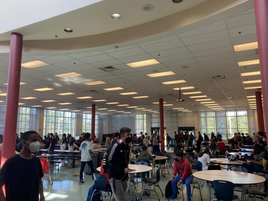 The long lunch line wraps around the cafeteria. Students make use of the free lunch that the county is currently providing due to Covid.