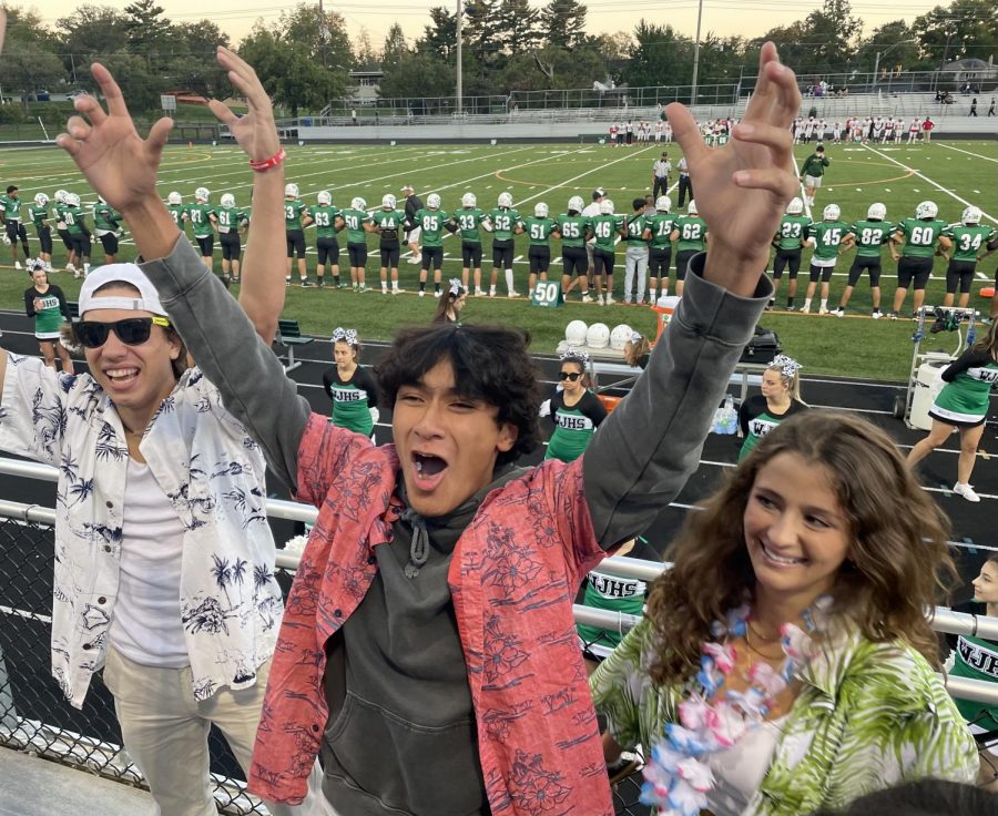 From left: Seniors JP Rakis, Alejandro Linares and Sofia Orezzoli muster up some energy to hype up the crowd before kickoff. Drumless, they still were able to succeed in doing so.