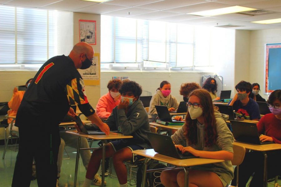 English teacher Marc Waldman assists a student with an English assignment on his Chromebook. Waldman encourages questions and participation in the classroom. “I just hope that people always realize that they can approach me, and if I can’t help them, I guarantee you, I know someone who can,” Waldman said.