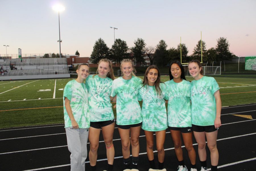 From left to right: Seniors Sydney Stein, Rachel Rinehart, Charlotte Thomas, Emma Kothari, Madeline Chung and Abby Calhoun pose just before their senior night ceremony. It was really special to walk out with my family and see my friends do it as well, Stein said.