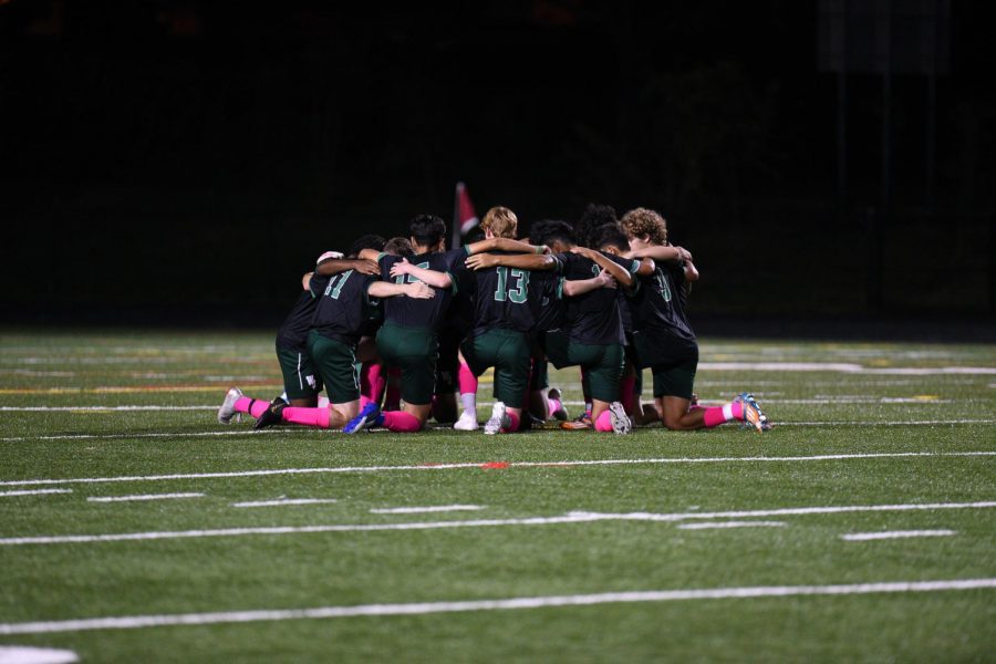 The+starting+lineup+for+the+WJ+boys+varsity+soccer+team+kneels+in+a+huddle+together+before+a+regular+season+game+against+Churchill.+This+has+become+a+ritual+they+do+before+every+game.