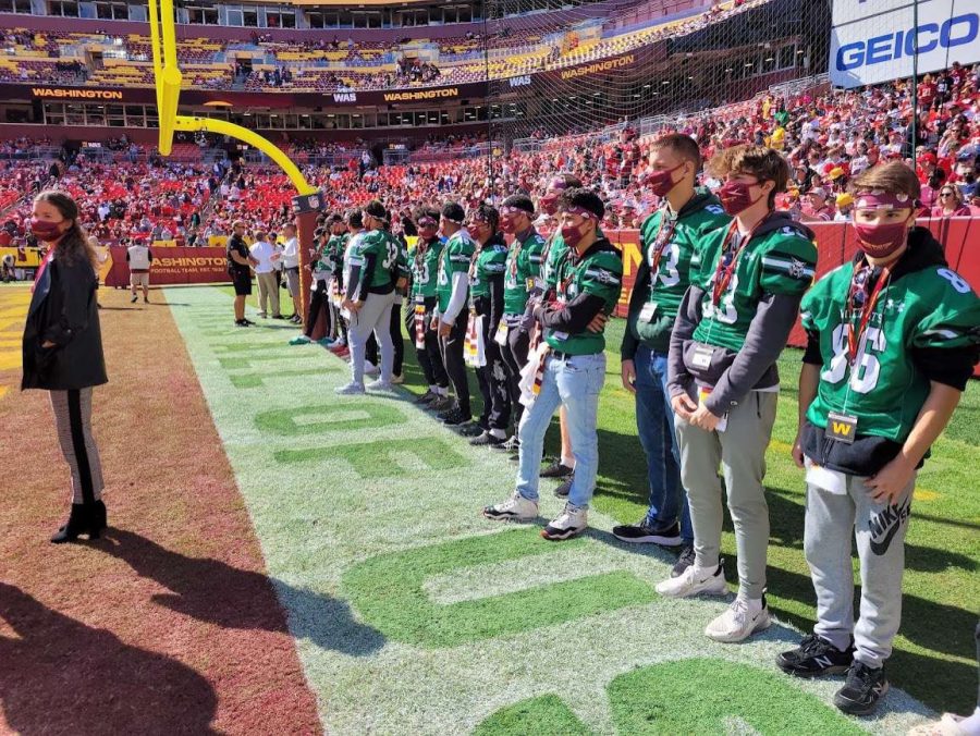 WJ+football+stands+at+the+end+zone+of+the+Washington+field+watching+the+teams+warm-up.