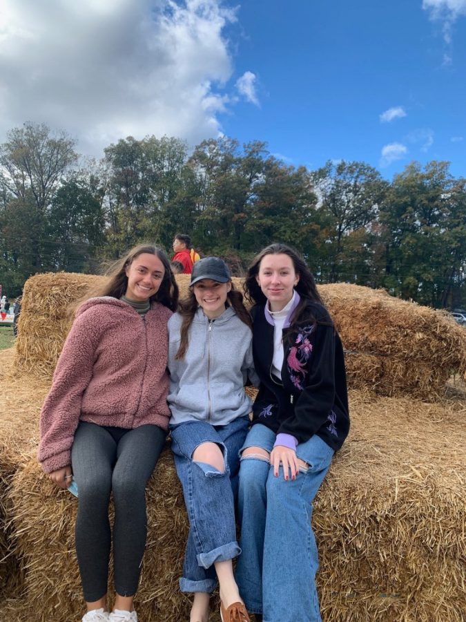 Seniors Isabelle Senfaute, Isa Bernat and Anderson Strong pose for a photo at Butlers Orchard. The site continues to be a popular attraction for those looking to participate in fall activities.